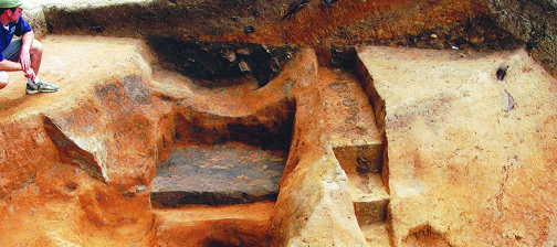 Archaeologist examines excavations