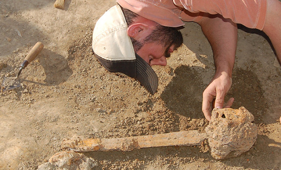 Archaeologist excavating a sword