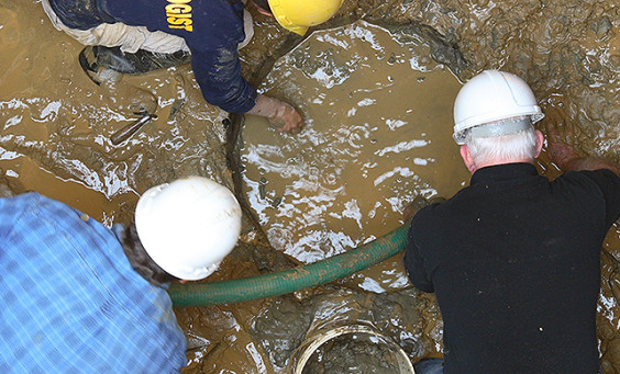 Archaeologists excavating a well