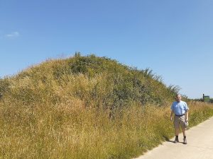 Dr. Eric Lapp stands in front of the Roman burial tumulus at Gingelom, Belgium, where four factory lamps closely similar to the Jamestown oil lamp were excavated in 1862. Photo courtesy of E. Lapp.