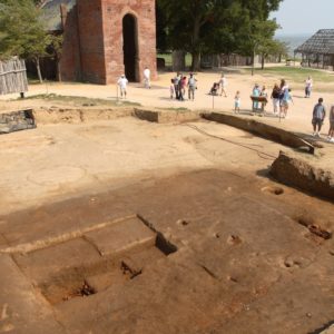 Demarcated features within a large excavation unit by a brick church