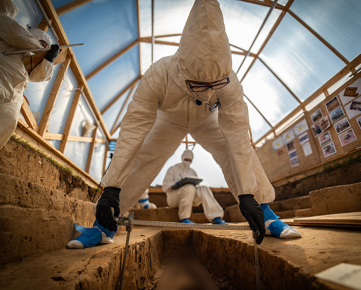 Forensic Anthropologist Dr. Ashley McKeown takes measurements of one of the skeletons (human remains intentionally obscured).