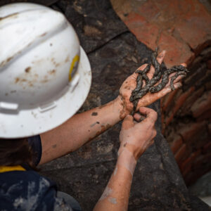 Senior Staff Archaeologist Mary Anna Hartley examines rope fragments found in the Governor's Well.