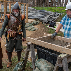 Director of Living Trades Willie Balderson (dressed as colonist Anas Todkill) discusses some of the finds with Archaeological Conservator Dr. Chris Wilkins.