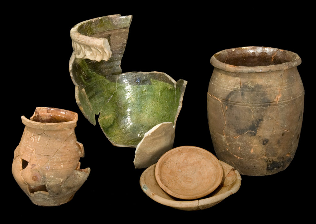 Four mended earthenware vessels