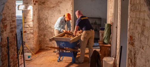 Senior Staff Archaeologist Mary Anna Hartley and Staff Archaeologist Caitlin Delmas screen for artifacts during the excavations in Bacon's Castle cellar.