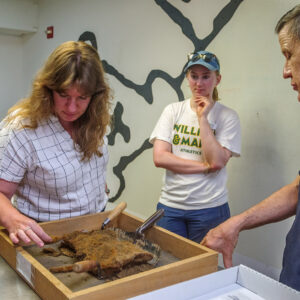 Senior Curator Leah Stricker, Development Writer Janne Wagner, and Conservator Don Warmke discuss the iron object Janne found during one of the staff dig days. Janne was an attendee of Jamestown's 2023 Field School.