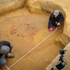 Archaeological Field Technician Gabriel Brown and Senior Staff Archaeologist Sean Romo prepare a grid for a ground-penetrating radar survey in the well/Confederate moat excavations.