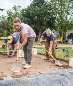 Collections Assistant Lindsay Bliss excavates a square south of the Archaearium on one of the staff dig days. Archaeological Field Technician Hannah Barch and Staff Archaeologist Caitlin Delmas are working in the same square.