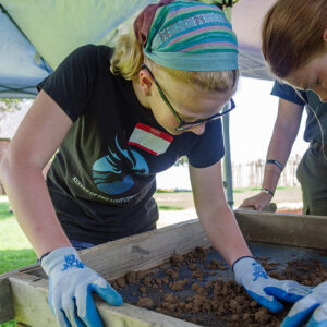 Two campers screening for artifacts