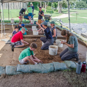 Campers and archaeologists at the cellar excavations