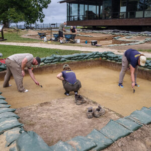 Director of Archaeology Sean Romo and Archaeological Field Technicians Ren Willis and Hannah Barch score features in a square south of the Archaearium. This square contains the burial that will be excavated in the next few weeks. Two other burials are also in this square.