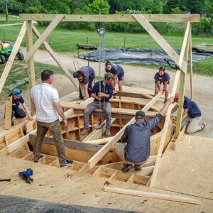 The Jamestown Rediscovery archaeology team slowly lowers the protective ring through the observation platform.