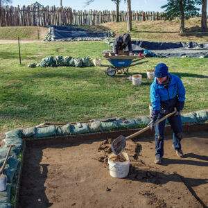 Staff Archaeologist Caitlin Delmas works to remove some of the layers at the excavations in the north field while archaeologist Eli Clem screens for artifacts.