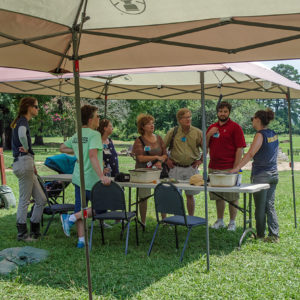 Staff and volunteers talk with visitors to the Angela Site