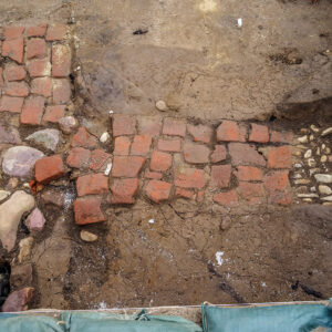 The chimney base of a ca. 1611 building built in the same location as the 1607 burial ground. The hearth was excavated in order to access the westmost grave.