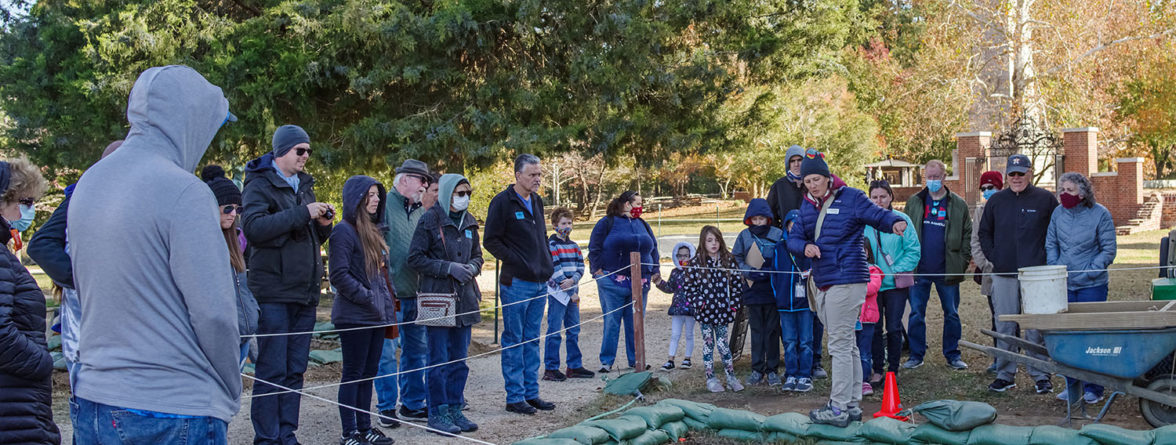 Senior Staff Archaeologist Mary Anna Hartley explains the north Church Tower excavations to visitors.