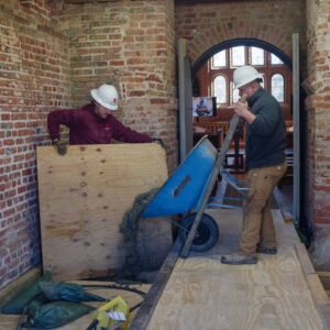 Contractors from Daniel and Company pour concrete for the glass floor footings.