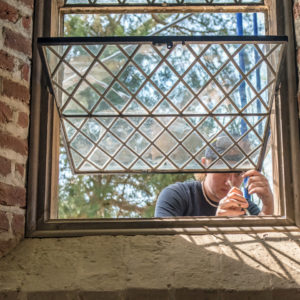 Restorer works on Memorial Church window