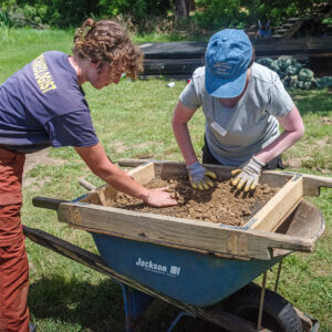 Archaeological Field Technician Brenna Fennessey and Field School student Sarah Hespe screening at the clay borrow pit excavations.