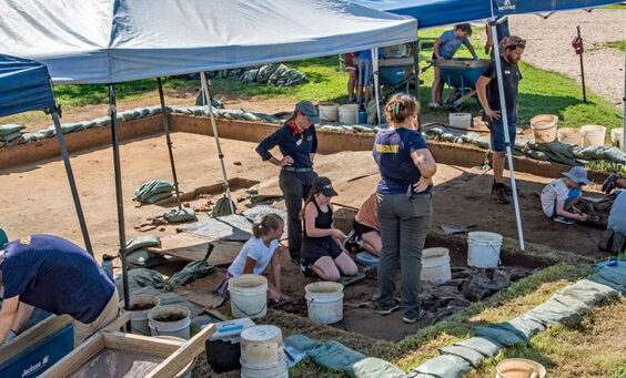 Campers and archaeologists at the cellar site
