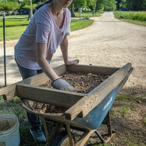 Field School student Katherine Griffith screening for artifacts.