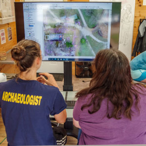 Site Supervisor Anna Shackelford uses GIS to discuss features found in the Memorial Church churchyard.