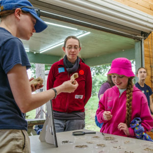 Visitors learning about some of the artifacts found on site.