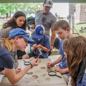 Staff Archaeologist Natalie Reid engages visitors in the Ed Shed.