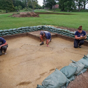 Archaeological Field Technicians Eleanor Robb, Josh Barber, and Hannah Barch score and take measurements of the three burials found inside a square just south of the Archaearium. The center one is scheduled for excavation in the coming weeks.