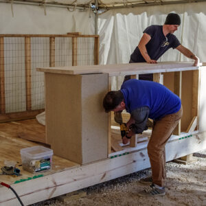 Director of Archaeology David Givens and Staff Archaeologist Gabriel Brown build the ticketing desk.