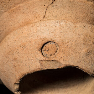 Doughnut-shaped rim of olive jar 03560-JR with a stamped circle owner's mark