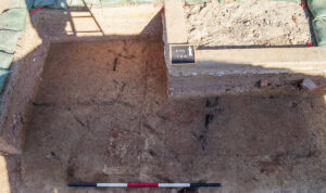 A partial view of the excavations south of the Archaearium. The blackened burned timber can be seen just right of center.