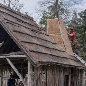 Carpenter Jesse Robertson works on the Blacksmith Shop's new chimney.