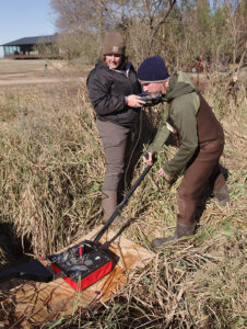 Archaeological Field Technician Hannah Barch and Staff Archaeologist Gabriel Brown conduct a GPR survey in the marsh north of James Fort.