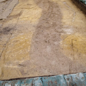 The dark brown soil of the zig-zag ditch near the clay borrow pit.