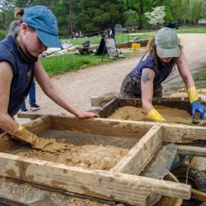 Staff Archaeologist Natalie Reid and Archaeological Field Technician Ren Willis water screen the soil excavated from the 1608 ditch.