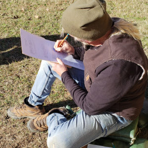 Archaeologist fills out field paperwork