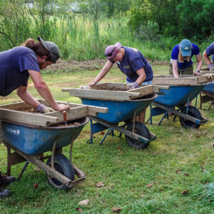 Screening for artifacts at the clay borrow pit excavations. (L-R) Archaeological Field Technician Josh Barber, Staff Archaeologist Caitlin Delmas, Archaeological Intern Janne Wagner, and Archaeological Field Technician Hannah Barch.