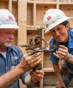 Director of Archaeology David Givens and Senior Staff Archaeologist Mary Anna Hartley examine the "fancy sword" found in the Governor's Well.