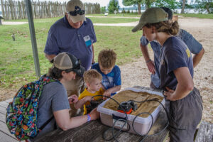 Young visitors to the Ed Shed search for buried objects in a sandbox using ground-penetrating radar (GPR). This activity is offered every Tuesday through July.