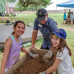 Senior Staff Archaeologist Sean Romo and campers screen for artifacts in the soil excavated from the clay borrow pit.