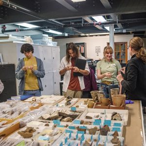 Associate Curator Janene Johnston shares artifacts with field school students in the Vault.