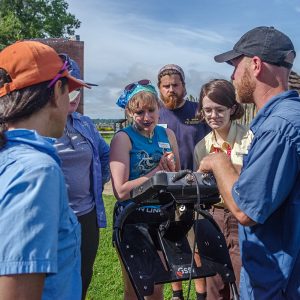 Director of Archaeology Sean Romo demonstrates use of a ground-penetrating radar (GPR) machine.