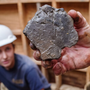 The burned wall fragment found in the Governor's Well