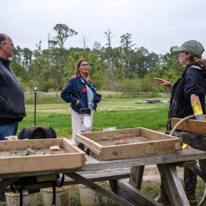 Archaeological Field Technician Ren Willis discusses the latest excavations with visitors.