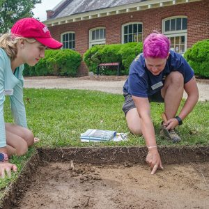 Field school student Natalie White and Staff Archaeologist Caitlin Delmas discuss the excavations outside the Dale House.