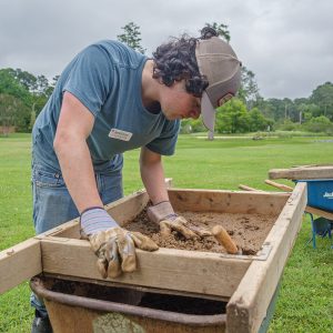 Field school student Calvin Boulier screens for artifacts at the excavations just outside the Dale House.