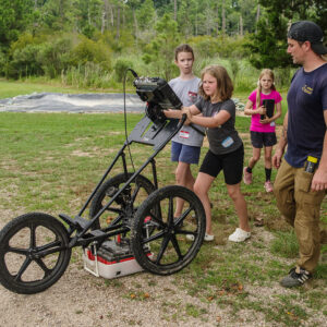 Campers conduct a ground-penetrating radar (GPR) survey northeast of the fort with guidance from Staff Archaeologist Gabriel Brown.