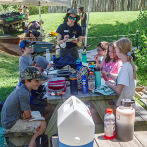 Staff Archaeologist Natalie Reid leads a journal exercise with the campers.